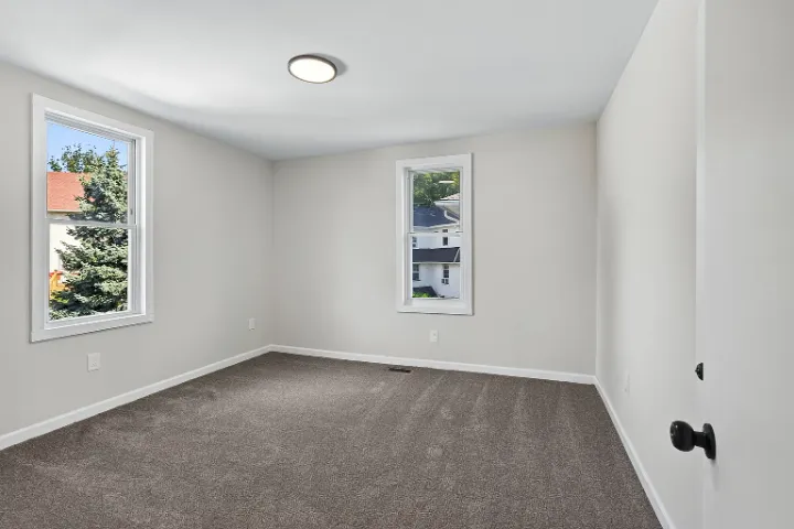 Bedroom with two windows and fresh carpet