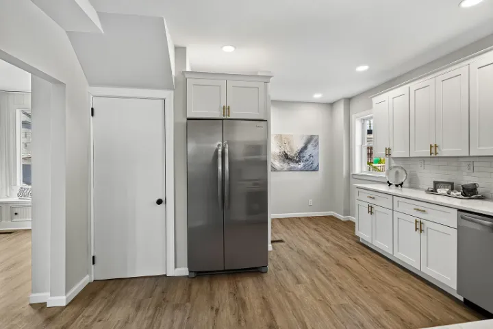 Kitchen with stainless refrigerator and brass hardware